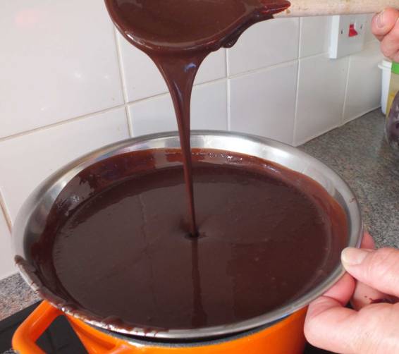 A bowl full of 70 percent chocolate over the double boiler.
